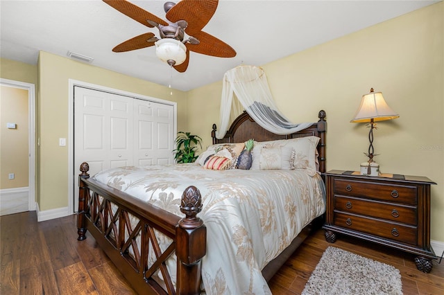 bedroom featuring dark hardwood / wood-style flooring, ceiling fan, and a closet