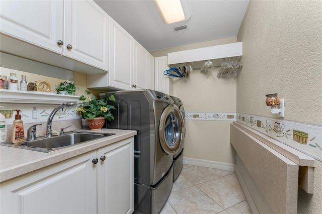 laundry room featuring cabinets, sink, independent washer and dryer, and light tile patterned floors