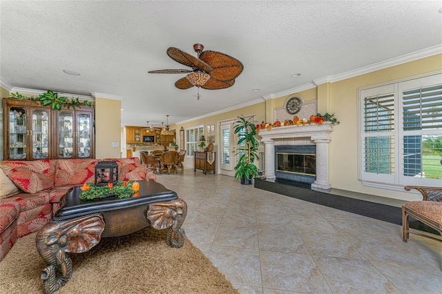 tiled living room featuring ornamental molding, a textured ceiling, a healthy amount of sunlight, and ceiling fan