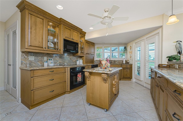 kitchen with black appliances, light tile patterned flooring, a kitchen island, pendant lighting, and decorative backsplash