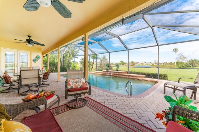 view of pool with glass enclosure, ceiling fan, and a patio area