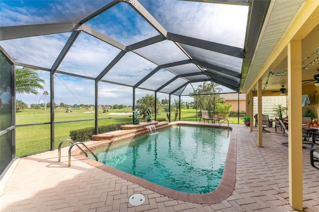 view of pool featuring ceiling fan, a yard, a patio, a lanai, and pool water feature