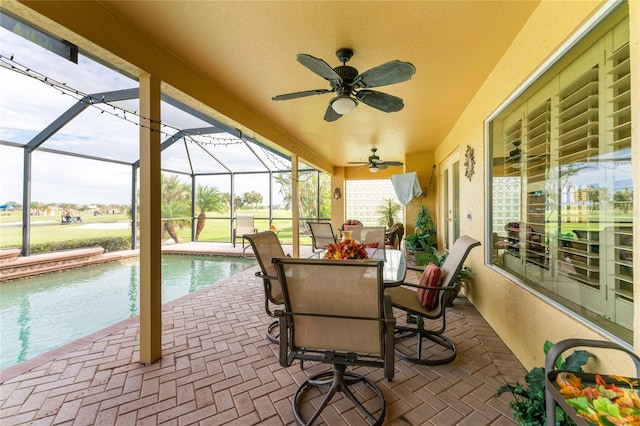 sunroom with a swimming pool and ceiling fan