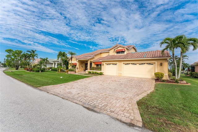 mediterranean / spanish house with a garage and a front yard