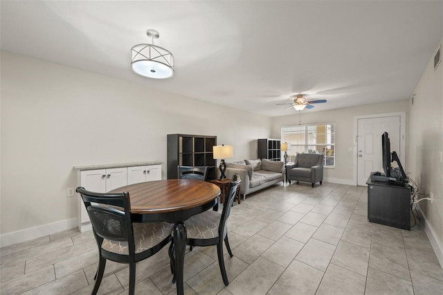 dining area with light tile patterned floors and ceiling fan