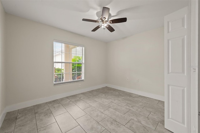 tiled empty room with ceiling fan