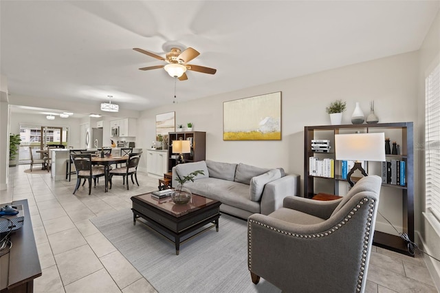 living room featuring light tile patterned floors and ceiling fan