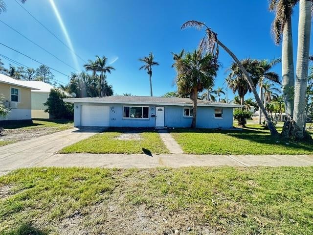 single story home with a garage and a front yard