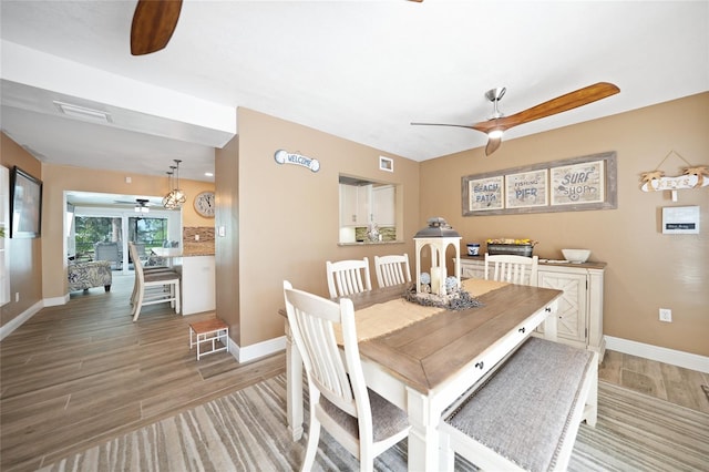 dining room featuring ceiling fan and wood-type flooring