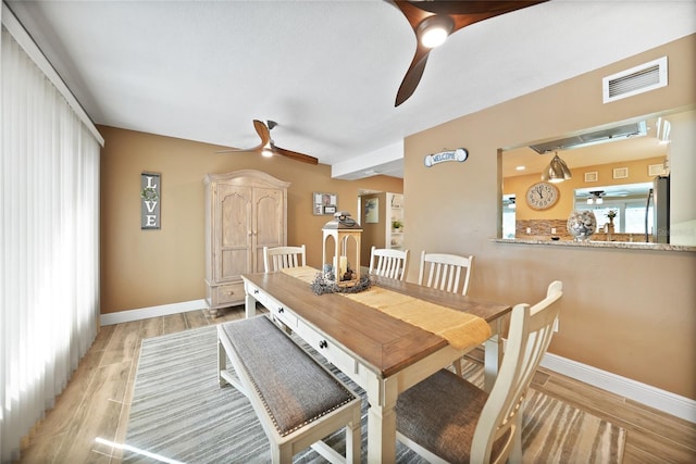 dining room with ceiling fan and light wood-type flooring