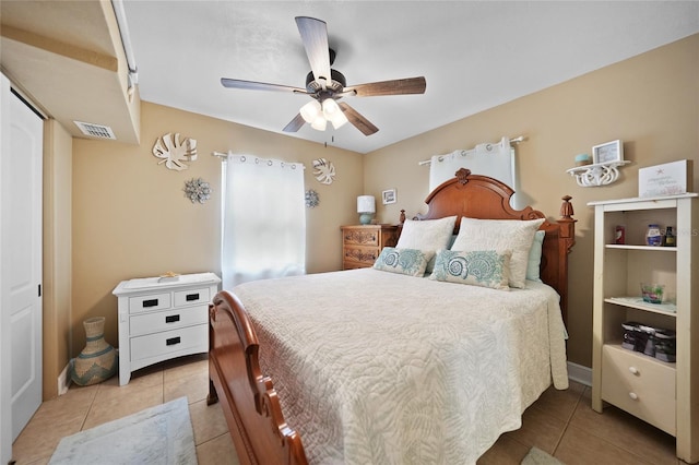 bedroom with a closet, tile patterned floors, and ceiling fan