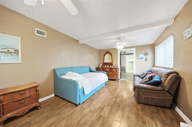 bedroom featuring lofted ceiling with beams, wood-type flooring, and ceiling fan