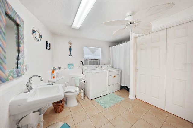 bathroom with ceiling fan, separate washer and dryer, tile patterned floors, and toilet