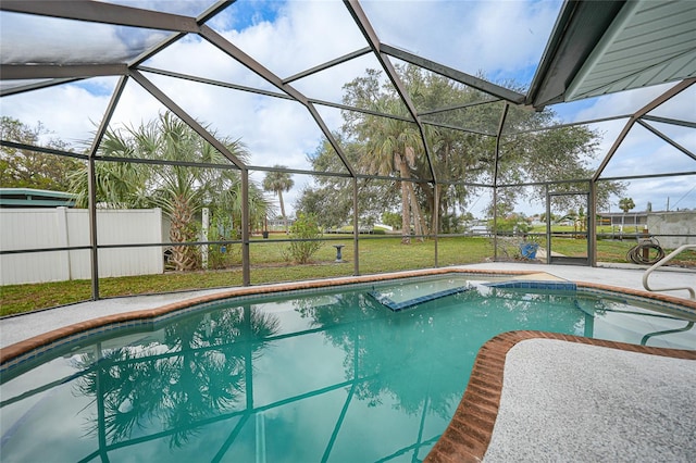 view of pool with a lanai, a lawn, and a patio