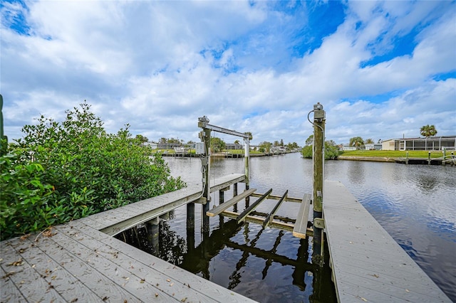 view of dock featuring a water view and glass enclosure