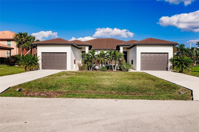 view of front of property with a garage and a front yard