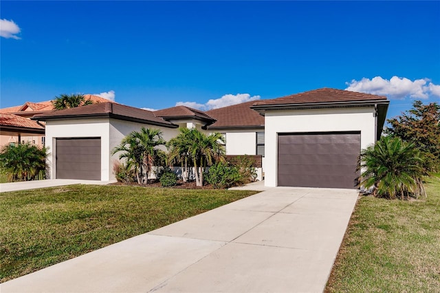 view of front of home featuring a garage and a front lawn