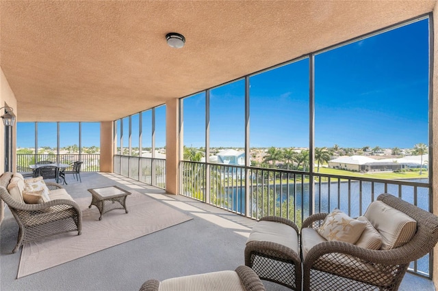 sunroom / solarium featuring a water view