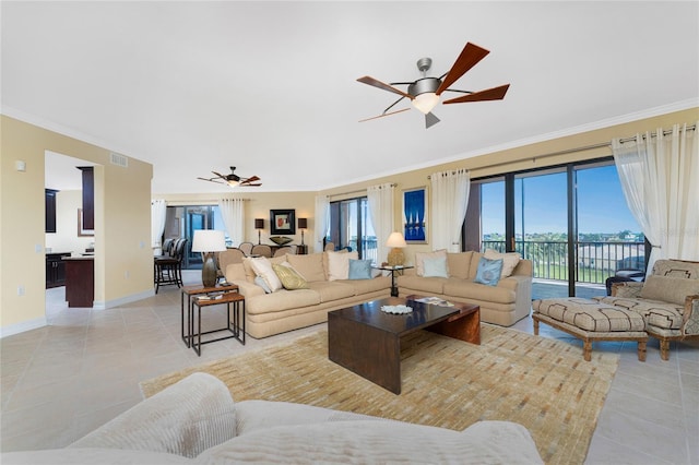 tiled living room featuring ceiling fan and ornamental molding