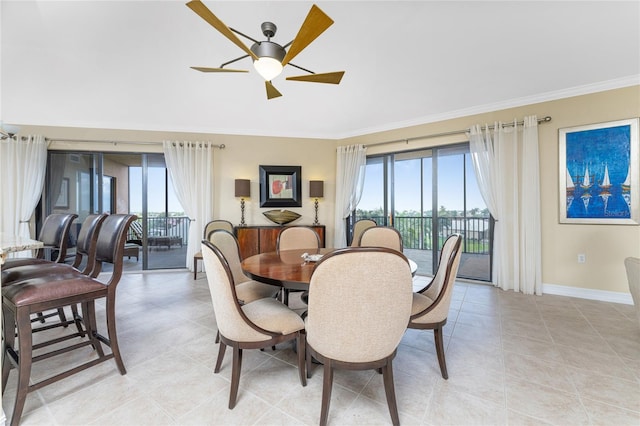 tiled dining space featuring ceiling fan and ornamental molding