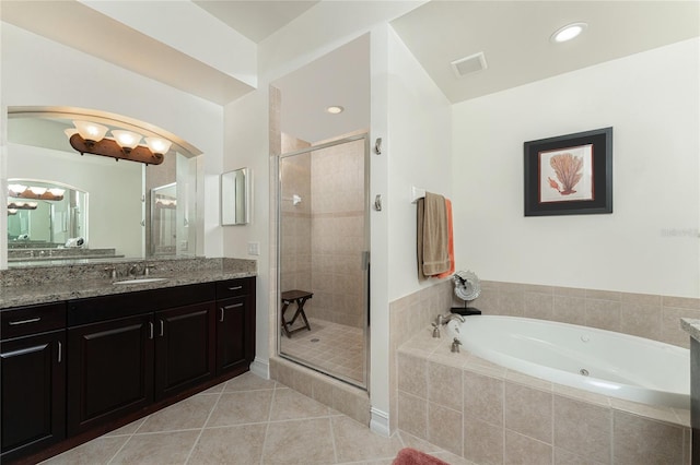 bathroom with tile patterned floors, vanity, and shower with separate bathtub