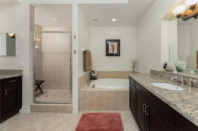 bathroom featuring tile patterned flooring, vanity, and shower with separate bathtub