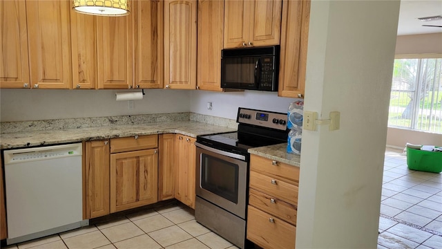 kitchen featuring stainless steel electric range oven, light stone countertops, light tile patterned floors, and white dishwasher