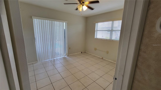 spare room with light tile patterned flooring and ceiling fan