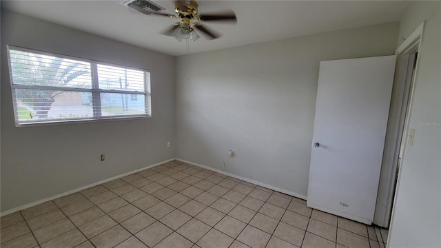 unfurnished room with ceiling fan and light tile patterned floors