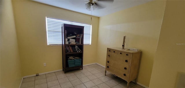 interior space with light tile patterned flooring and ceiling fan