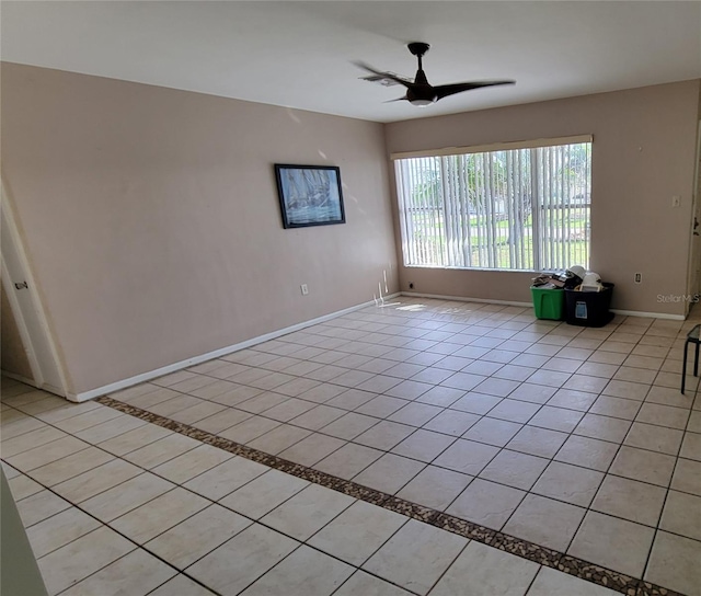 tiled empty room with ceiling fan