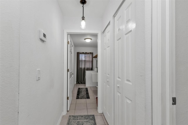 hall featuring light tile patterned floors