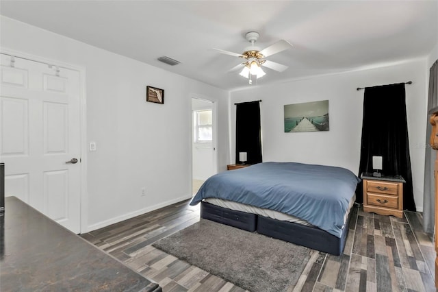 bedroom featuring connected bathroom, ceiling fan, and dark hardwood / wood-style floors