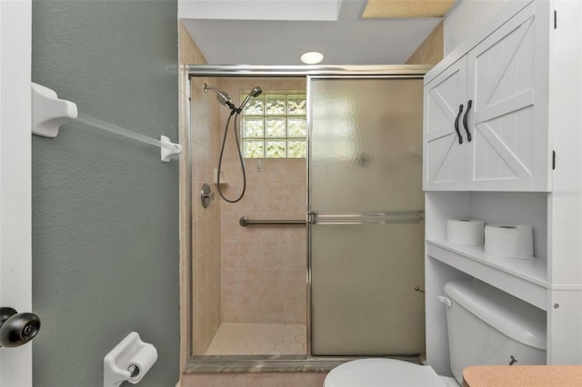 bathroom with an enclosed shower and toilet