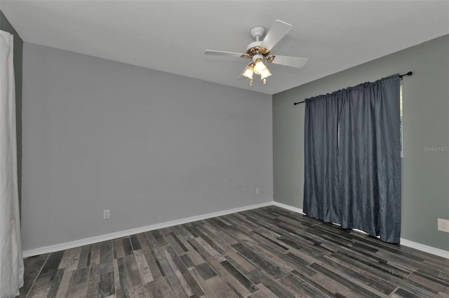 spare room featuring dark hardwood / wood-style floors and ceiling fan