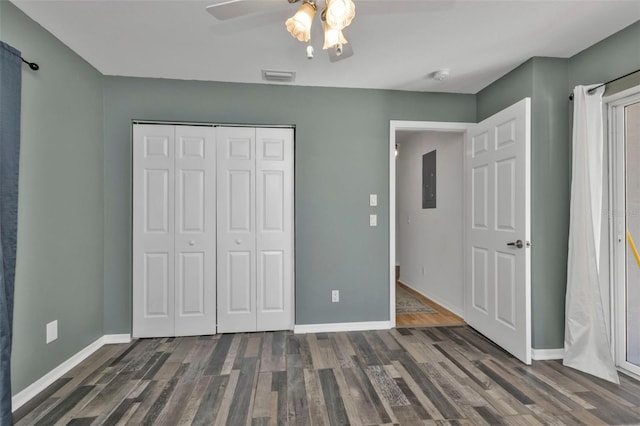 unfurnished bedroom featuring ceiling fan, dark hardwood / wood-style floors, electric panel, and a closet