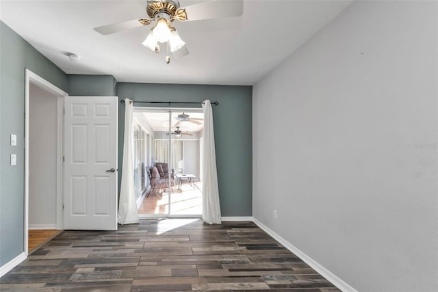 unfurnished room with ceiling fan and dark hardwood / wood-style floors