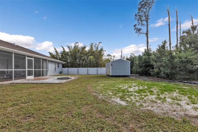 view of yard featuring a shed and a sunroom