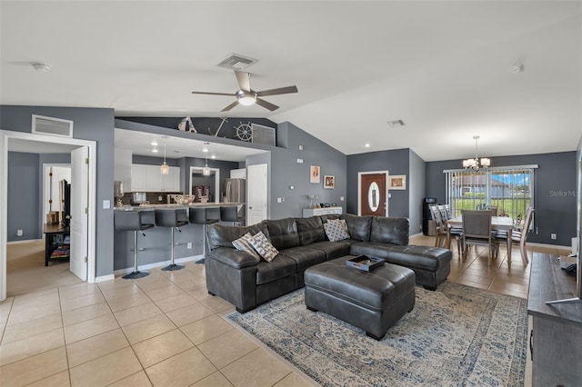 tiled living room featuring lofted ceiling and ceiling fan with notable chandelier