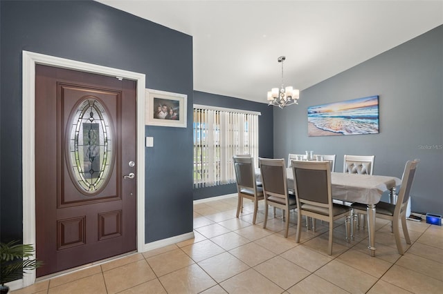 tiled dining space featuring vaulted ceiling and an inviting chandelier