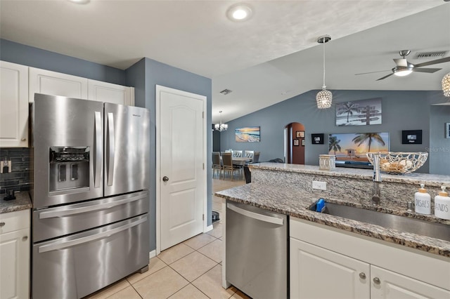 kitchen featuring white cabinets, lofted ceiling, sink, and appliances with stainless steel finishes