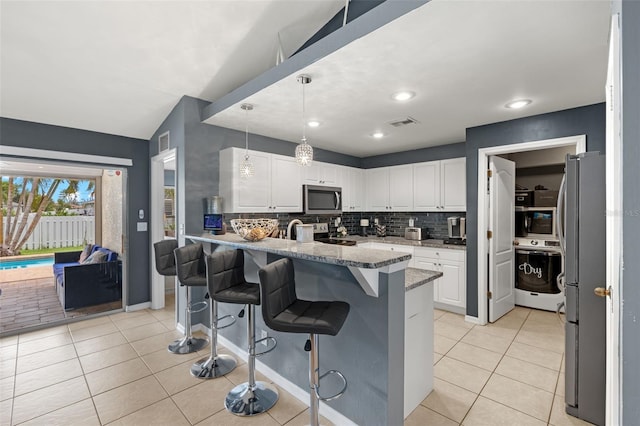 kitchen with appliances with stainless steel finishes, decorative backsplash, and white cabinets