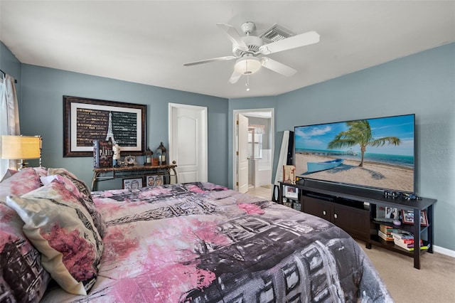 bedroom featuring ensuite bathroom, ceiling fan, and light colored carpet