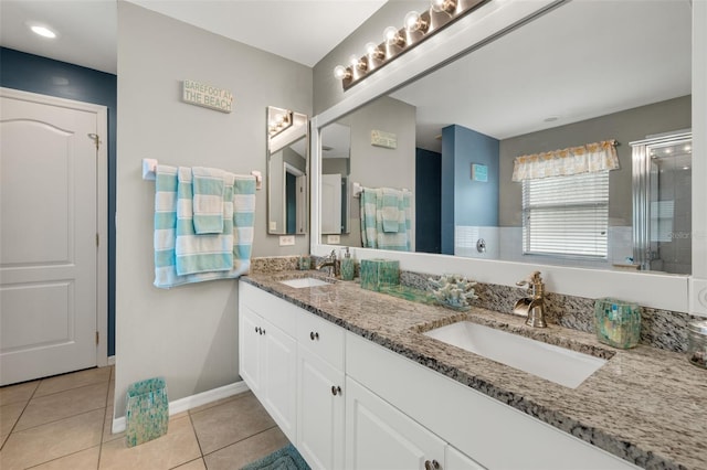 bathroom with vanity, tile patterned floors, and a shower with door