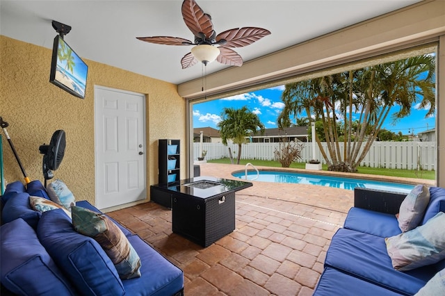 view of patio / terrace featuring ceiling fan and a fenced in pool