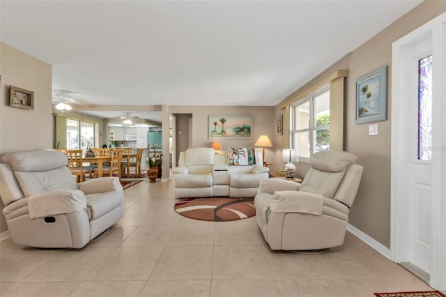 living room featuring ceiling fan and light tile patterned floors