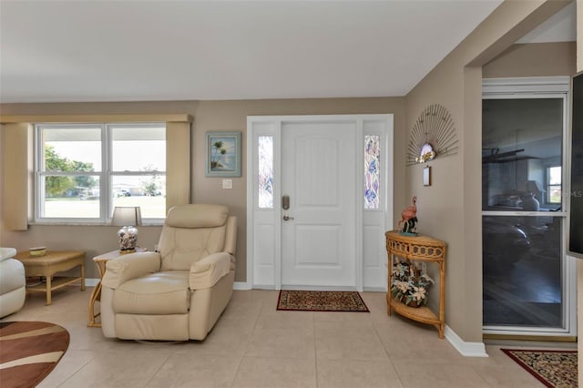 foyer entrance with light tile patterned flooring