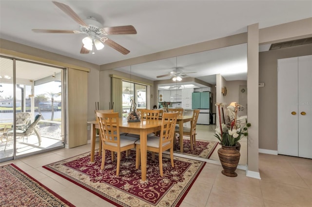 tiled dining area with ceiling fan