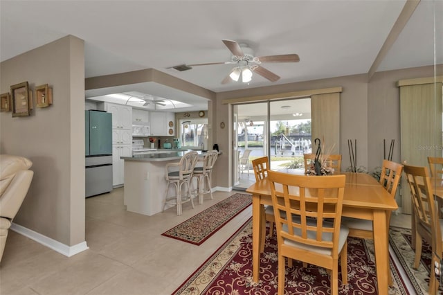 dining room with light tile patterned floors and ceiling fan