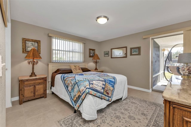 bedroom featuring access to exterior and light tile patterned floors